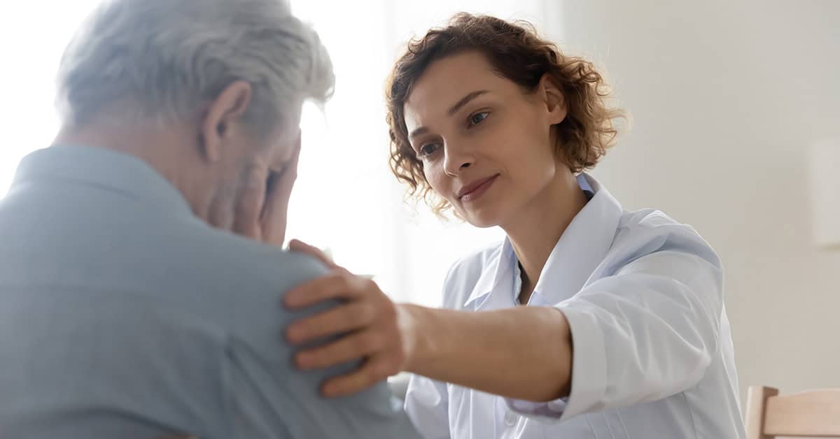 Confused senior patient being consoled by caretaker